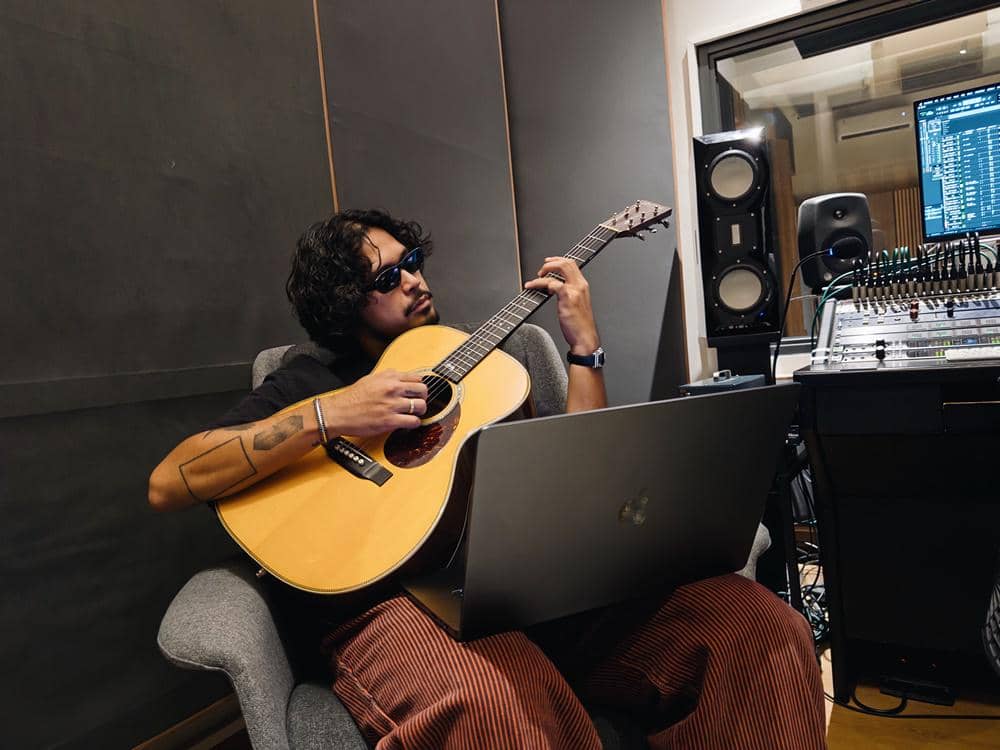 Petra Sihombing composing music with guitar and MacBook Pro M4 Max (3).JPG