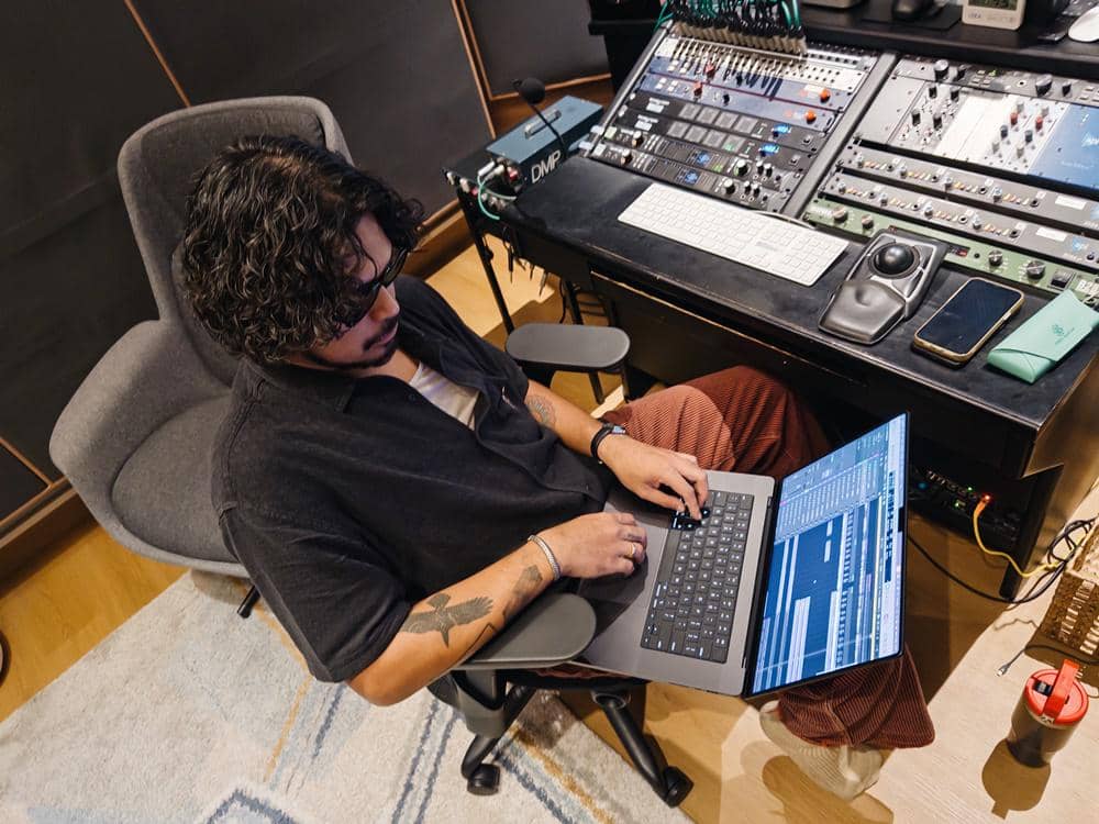 Petra Sihombing creating music on his MacBook Pro and Logic Pro..JPG