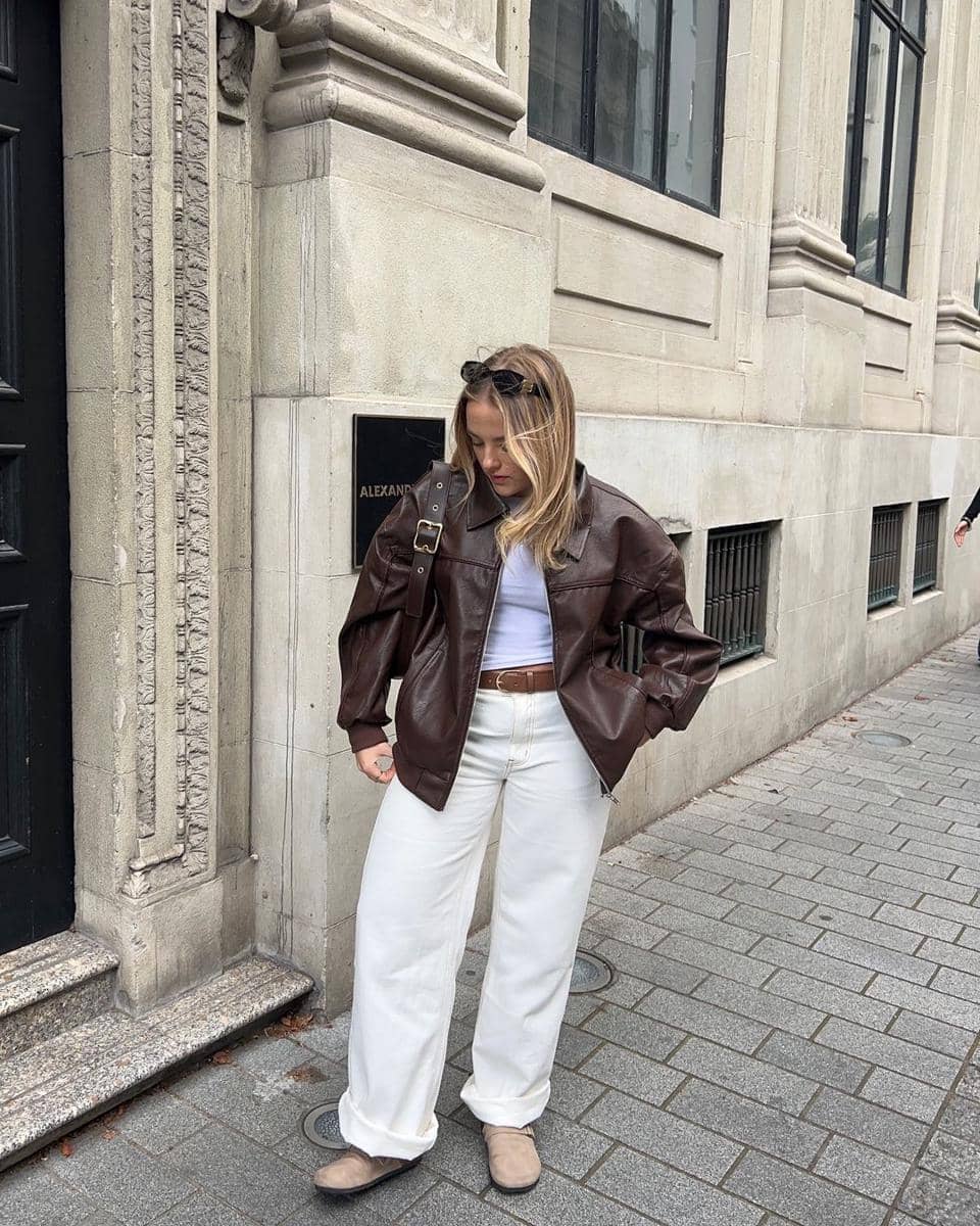 A-dark-brown-leather-jacket-with-a-boxy-fit-and-rounded-collar.jpg