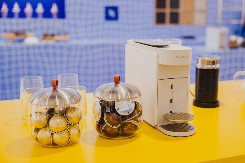 Mesin kopi Vertuo Up dari Nespresso yang hadir dalam acara Nespresso Vertuo World, dengan desain perangkat penyeduh kopi modern.